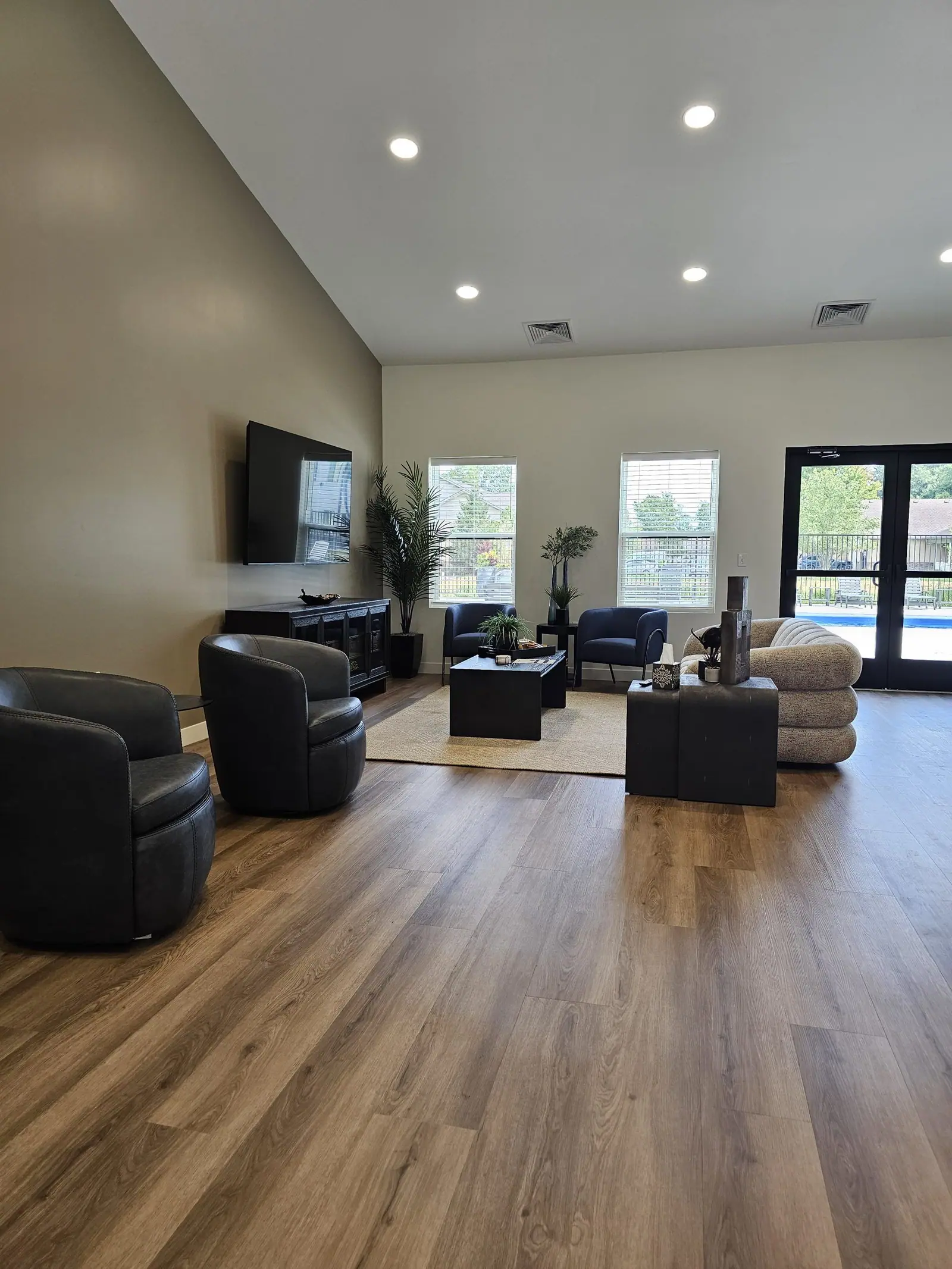 Clubhouse lounge at District Flats with seating and a wall-mounted TV